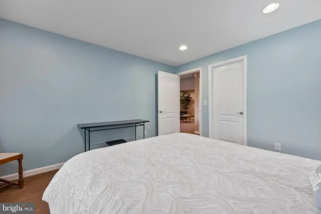 a picture of a room with a white wall and a painting