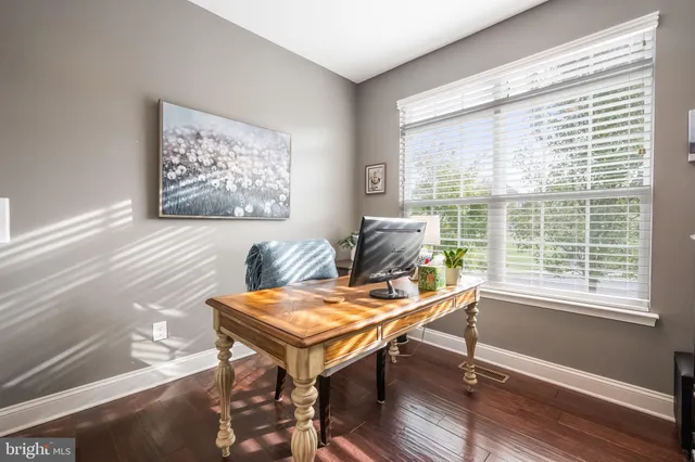 a bathroom with a granite countertop toilet sink and mirror