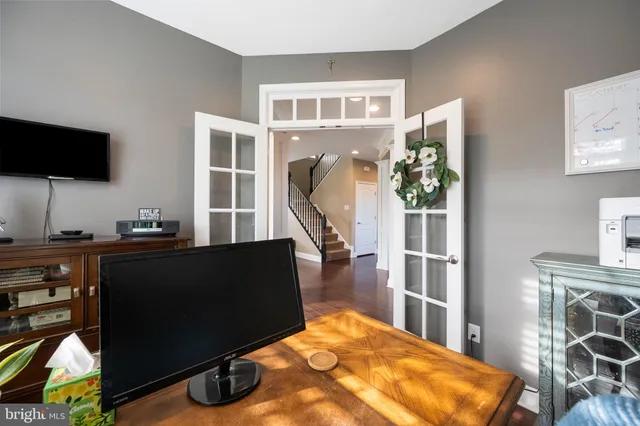 a dining room with furniture a chandelier and wooden floor