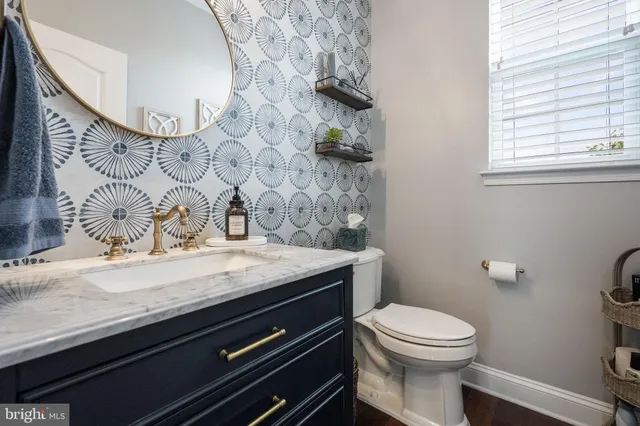 a dining room with furniture a chandelier and wooden floor