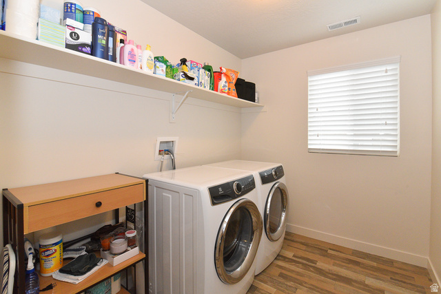 1632 North Apache Road Saratoga Springs, UT 84045 - Photo 25 of 28 Dedicated laundry space featuring wood-finish flooring and a window with blinds