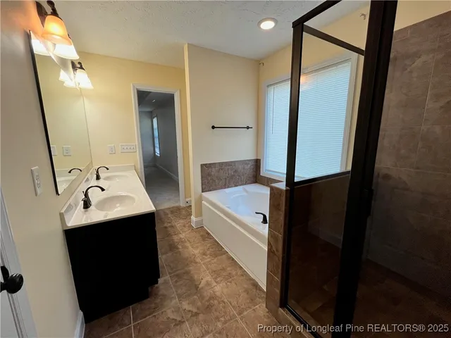 a bathroom with a sink a mirror and a bathtub