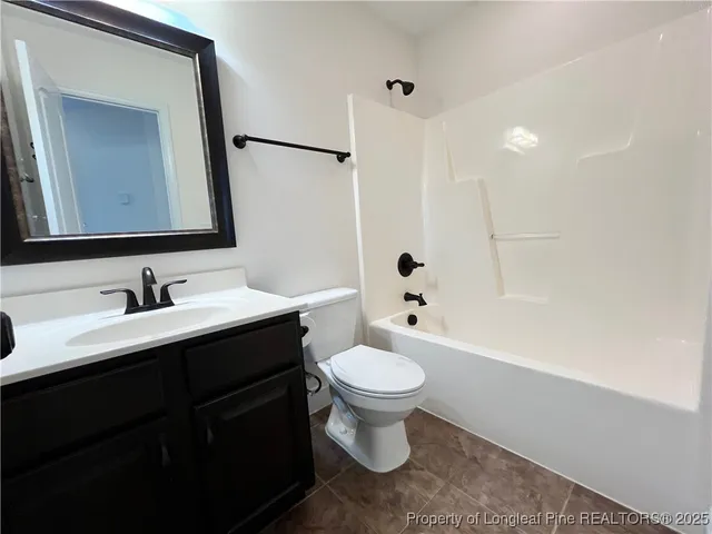 a bathroom with a sink toilet a mirror and shower