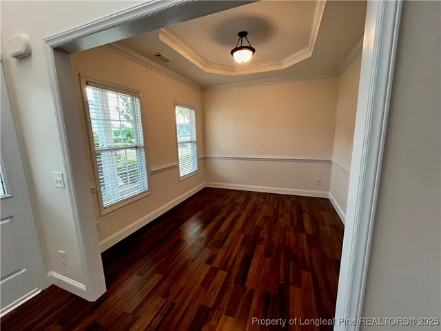 a view of a room with wooden floor and window