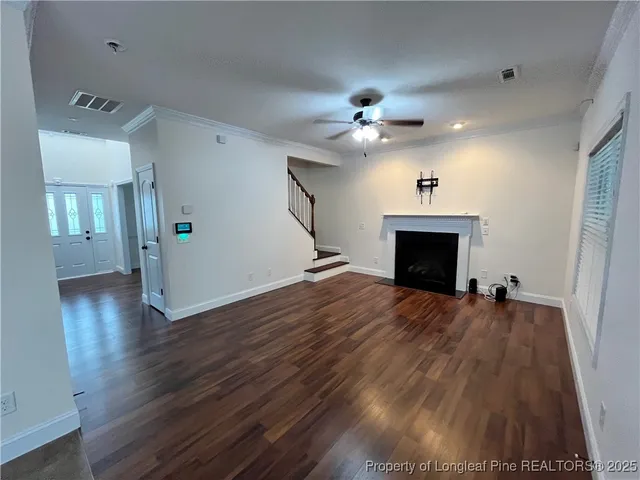 wooden floor in an empty room with a fireplace