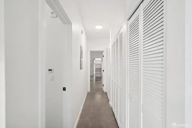 a view of a hallway with wooden floor