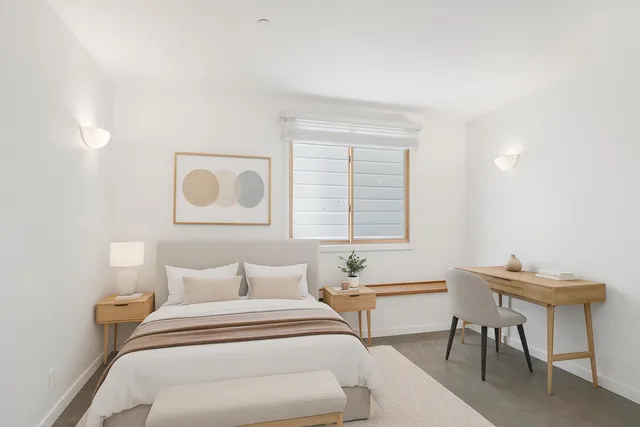 a bedroom with a bed and a table