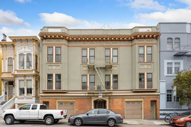 a front view of a building with parking space