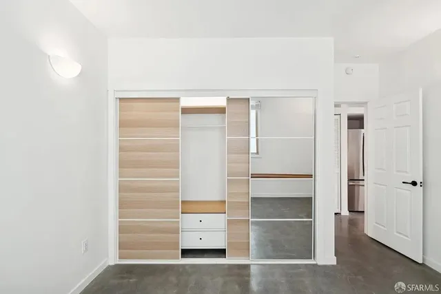 a bedroom with a bed and a night stand