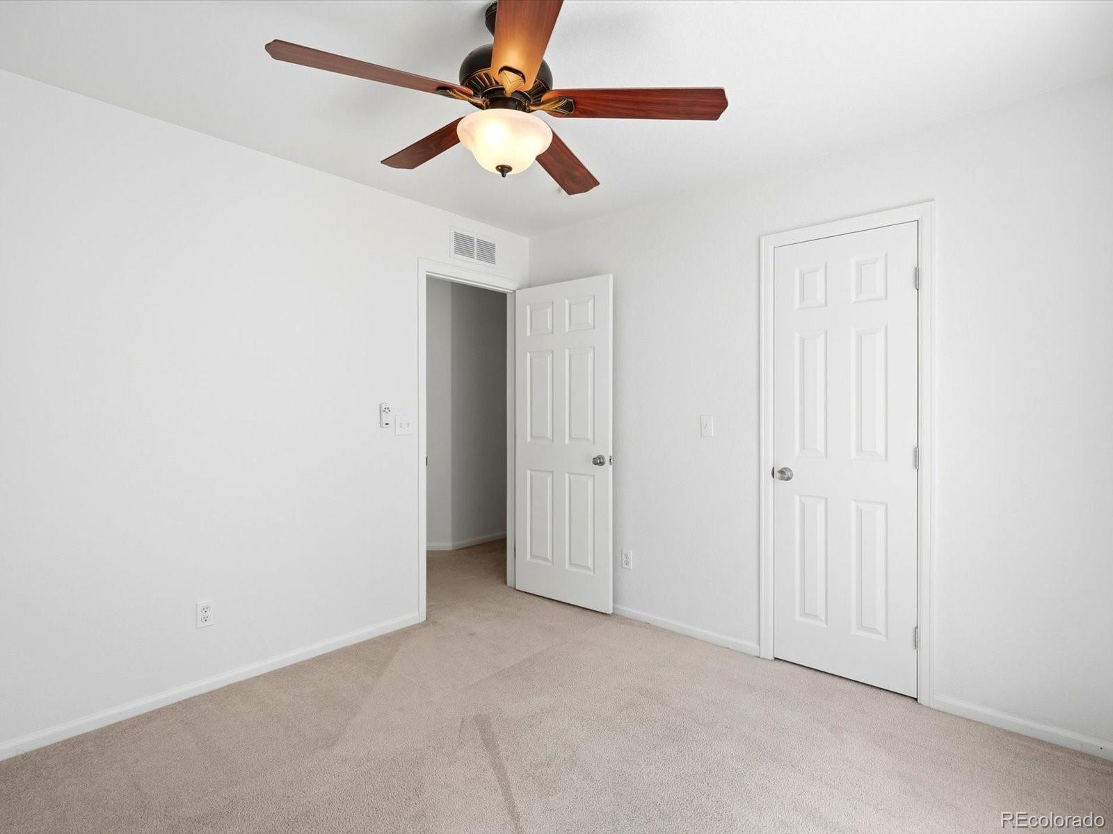 5444 Perth Court Denver, CO 80249 - Photo 37 of 46 an empty room with a ceiling fan and a window