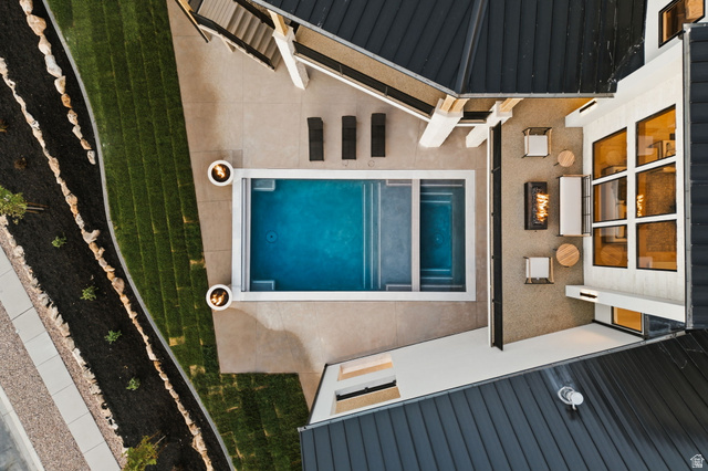 923 North Emery Lane Elk Ridge, UT 84651 - Photo 93 of 101 Outdoor living space featuring a rectangular swimming pool with integrated spa, adjacent patio with fire pit, and a multi-level deck