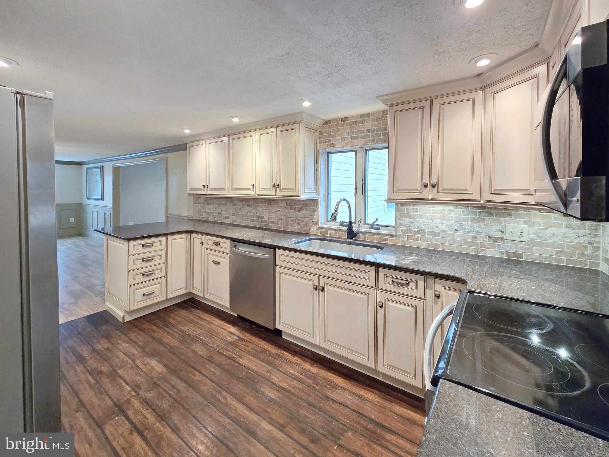 31 Diverty Road Pennington, NJ 08534 - Photo 7 of 29 a kitchen with stainless steel appliances granite countertop a sink a stove a refrigerator and cabinets