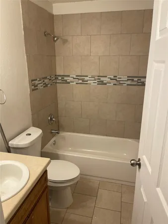 a bathroom with a toilet a sink and bathtub