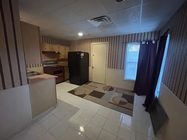 a kitchen with a refrigerator and a sink
