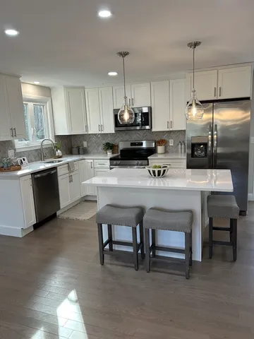 a kitchen with a sink cabinets and window