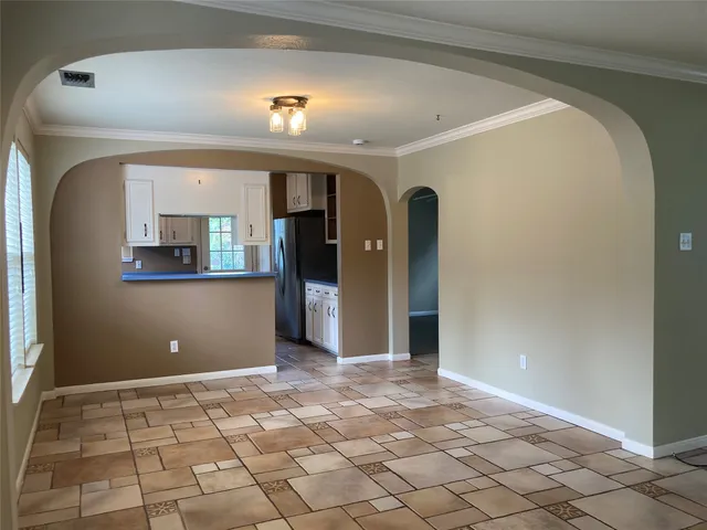 a view of a big room with wooden floor and windows