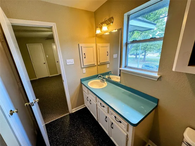 a bathroom with a sink a mirror and a toilet