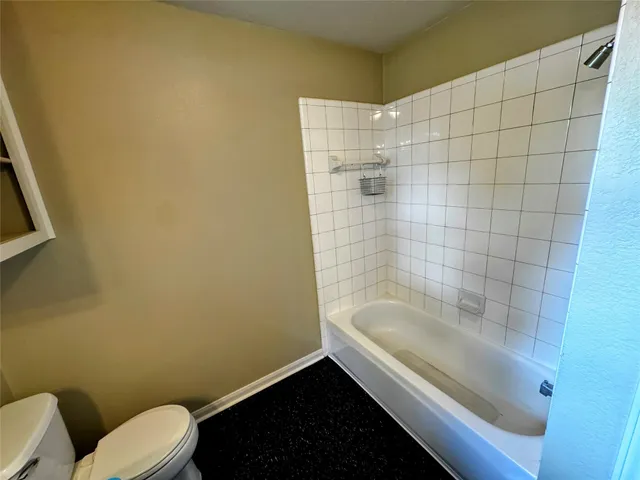 a bathroom with a bathtub and toilet