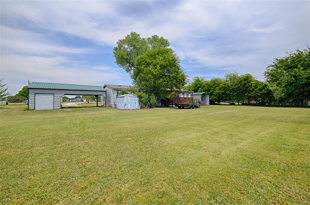 1670 Smith Circle Combine, TX 75159 - Photo 24 of 31 View of green lawn with a storage unit and a carport