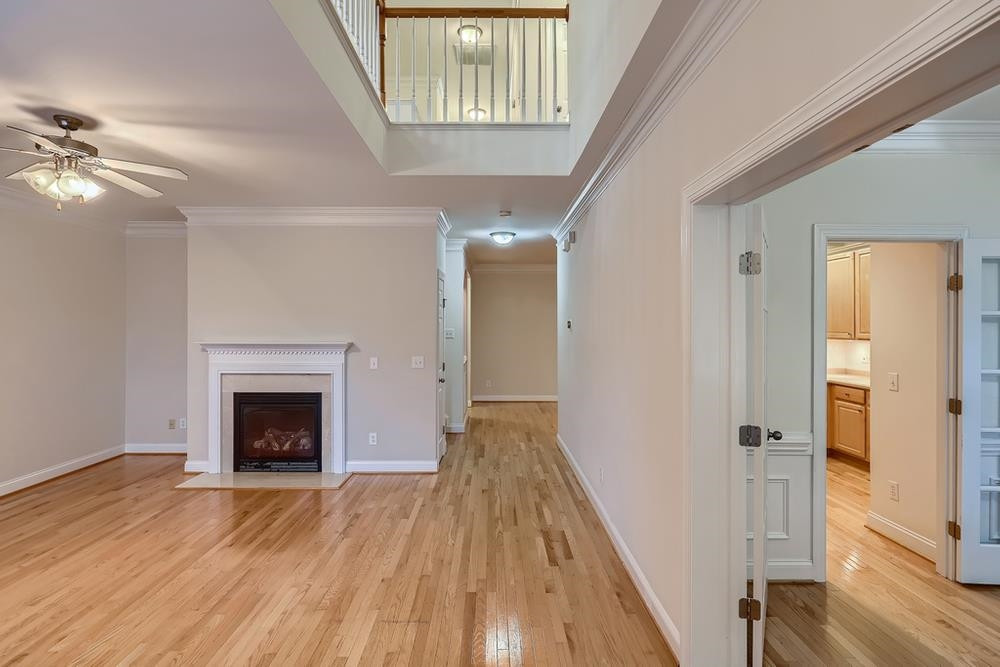10907 Flower Bed Court Raleigh, NC 27614 - Photo 4 of 28 a view of a hallway with wooden floor and staircase