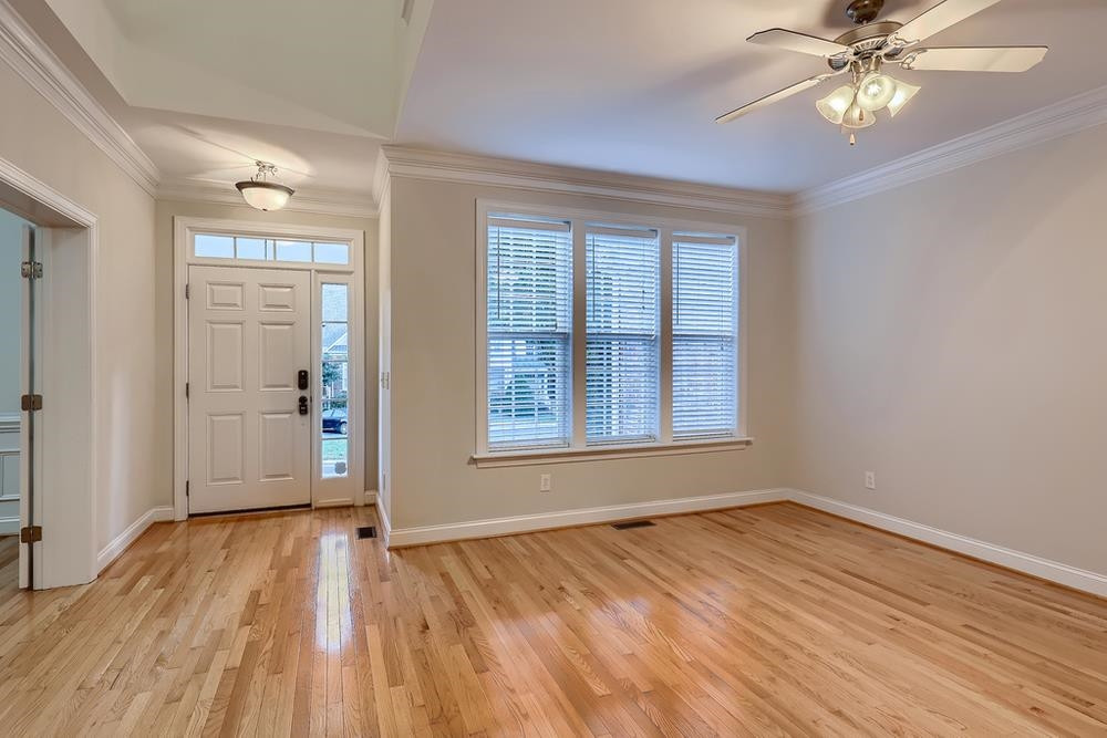 10907 Flower Bed Court Raleigh, NC 27614 - Photo 5 of 28 a view of empty room with wooden floor and fan