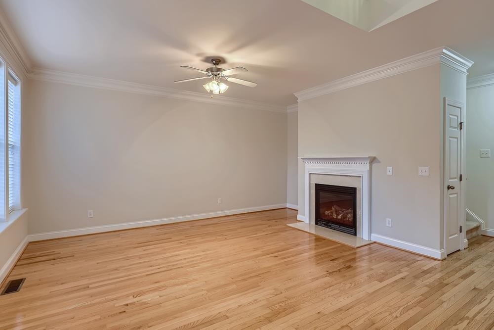 10907 Flower Bed Court Raleigh, NC 27614 - Photo 6 of 28 a view of empty room with wooden floor and fireplace