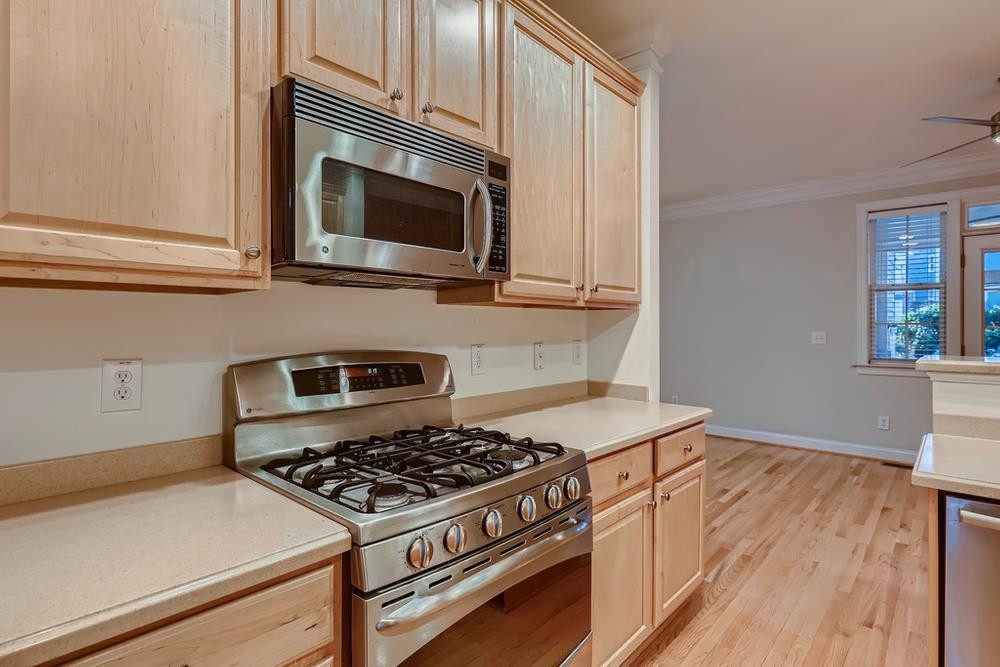 10907 Flower Bed Court Raleigh, NC 27614 - Photo 9 of 28 a kitchen with a stove and a microwave