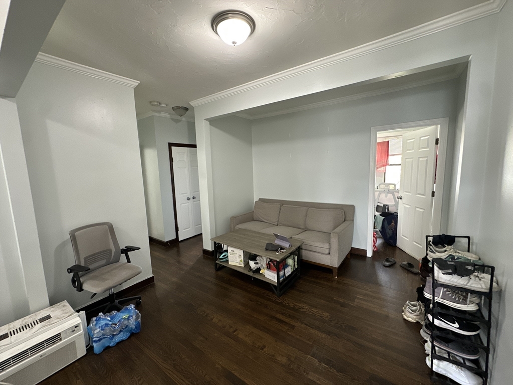435 Walnut Avenue, Unit 10 Boston, MA 02119 - Photo 1 of 18 a living room with furniture and wooden floor