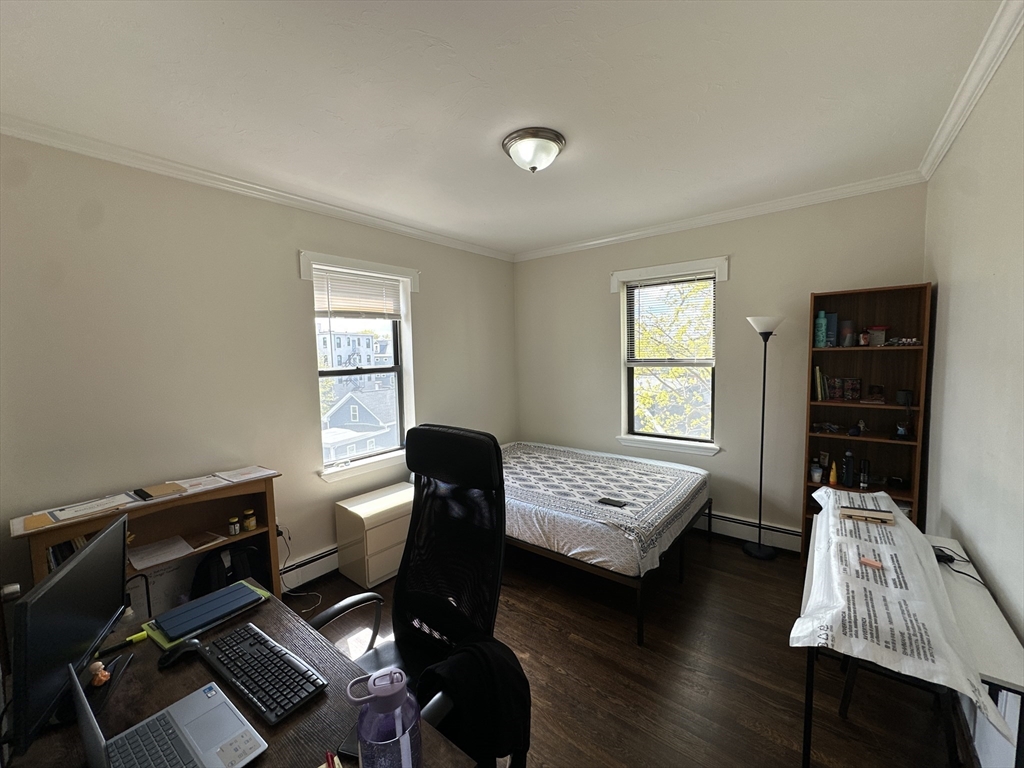 435 Walnut Avenue, Unit 10 Boston, MA 02119 - Photo 11 of 18 a living room with furniture window and wooden floor