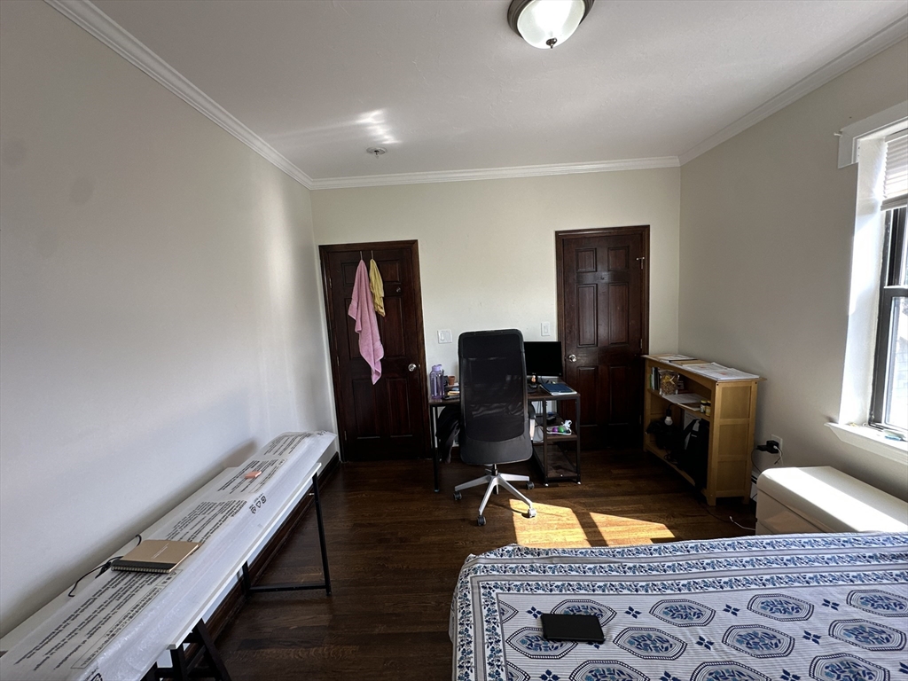 435 Walnut Avenue, Unit 10 Boston, MA 02119 - Photo 12 of 18 a living room with furniture and a flat screen tv