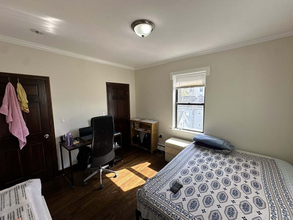 435 Walnut Avenue, Unit 10 Boston, MA 02119 - Photo 13 of 18 a living room with furniture and a window