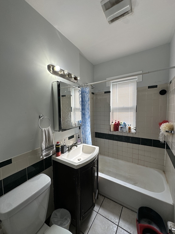 435 Walnut Avenue, Unit 10 Boston, MA 02119 - Photo 14 of 18 a bathroom with a tub sink and mirror