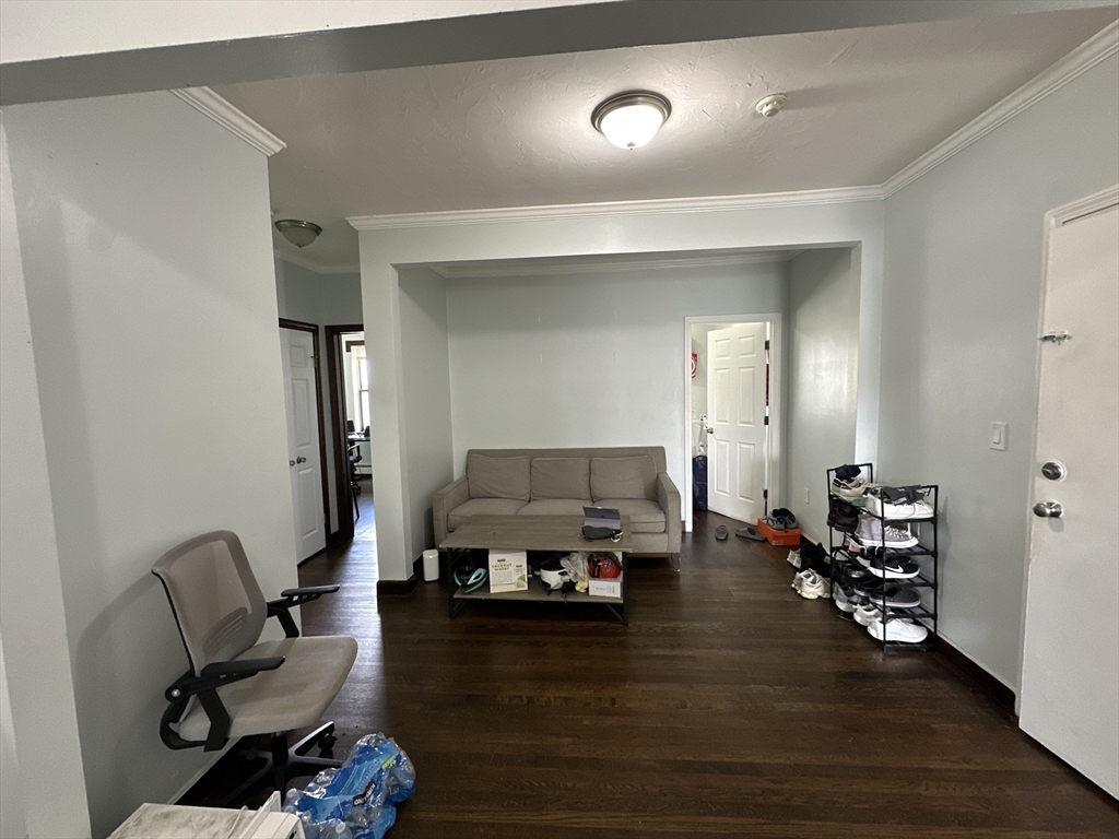 435 Walnut Avenue, Unit 10 Boston, MA 02119 - Photo 2 of 18 a living room with furniture and a wooden floor
