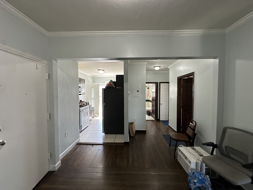 435 Walnut Avenue, Unit 10 Boston, MA 02119 - Photo 3 of 18 a hallway with wooden floor windows and livingroom