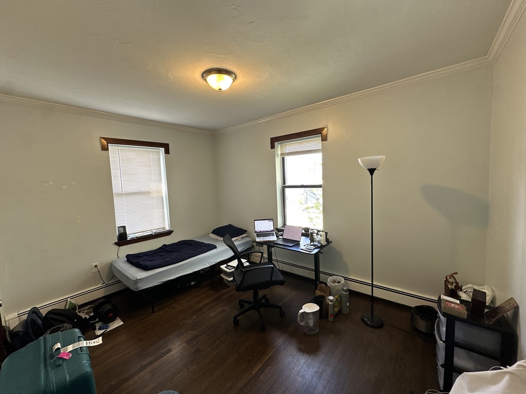 435 Walnut Avenue, Unit 10 Boston, MA 02119 - Photo 4 of 18 a room with furniture and a window