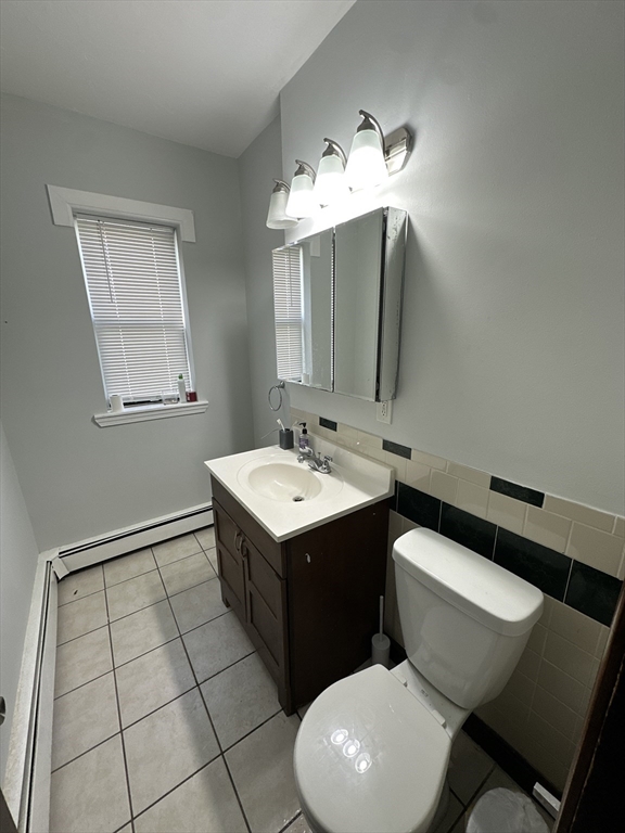 435 Walnut Avenue, Unit 10 Boston, MA 02119 - Photo 6 of 18 a bathroom with a sink vanity and toilet