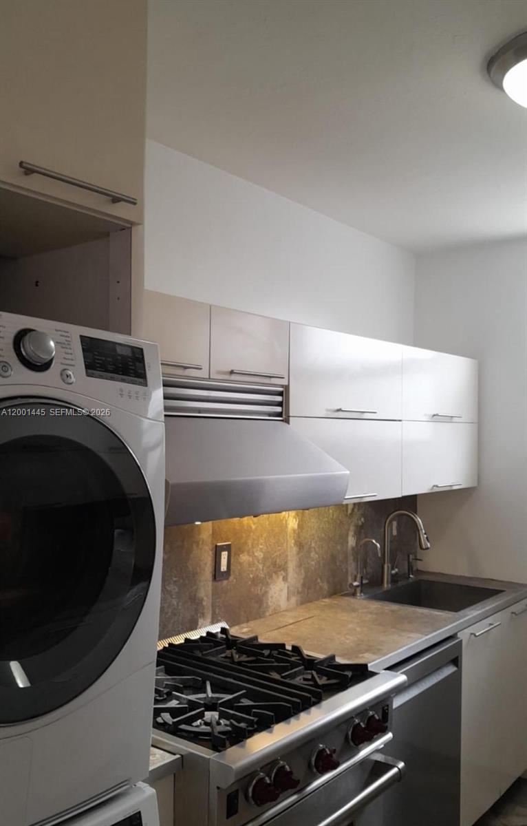 1300 Lincoln Road, Unit A301 Miami Beach, FL 33139 - Photo 14 of 23 a stove top oven sitting inside of a kitchen