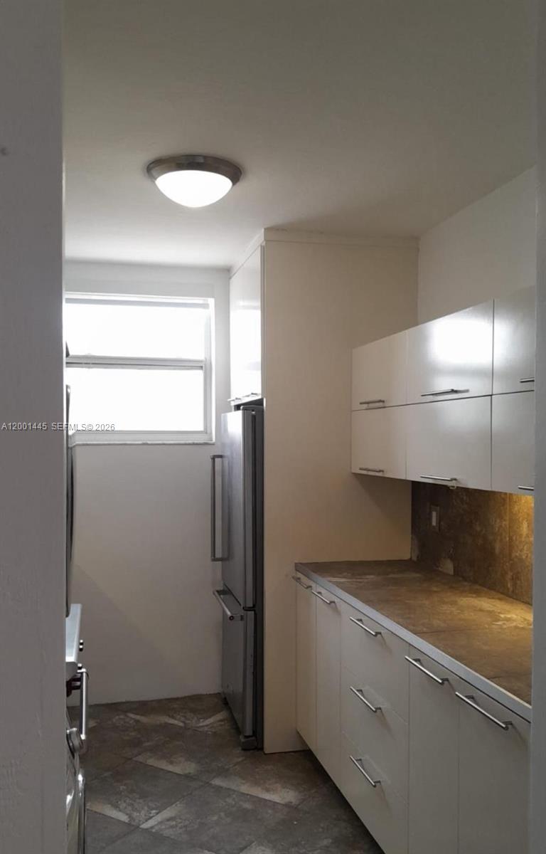 1300 Lincoln Road, Unit A301 Miami Beach, FL 33139 - Photo 16 of 23 a view of a refrigerator a sink and cabinets