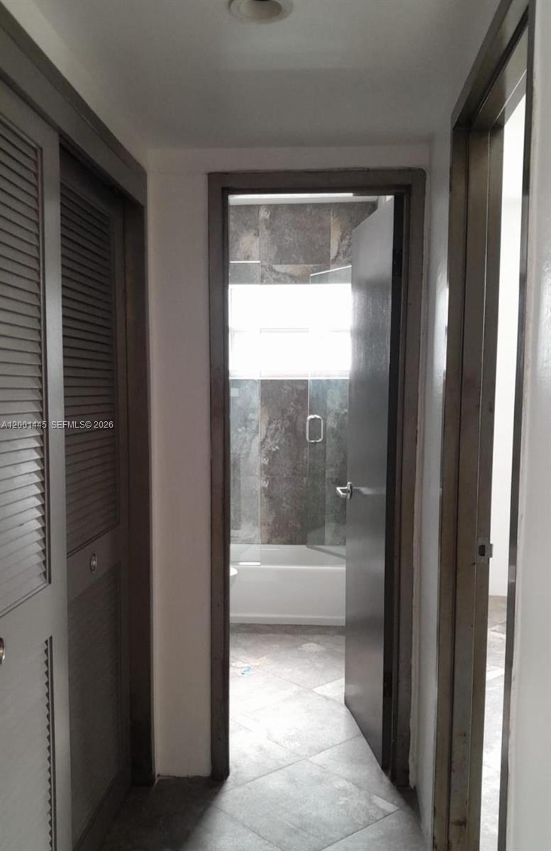 1300 Lincoln Road, Unit A301 Miami Beach, FL 33139 - Photo 17 of 23 a bathroom with a bathtub and a shower