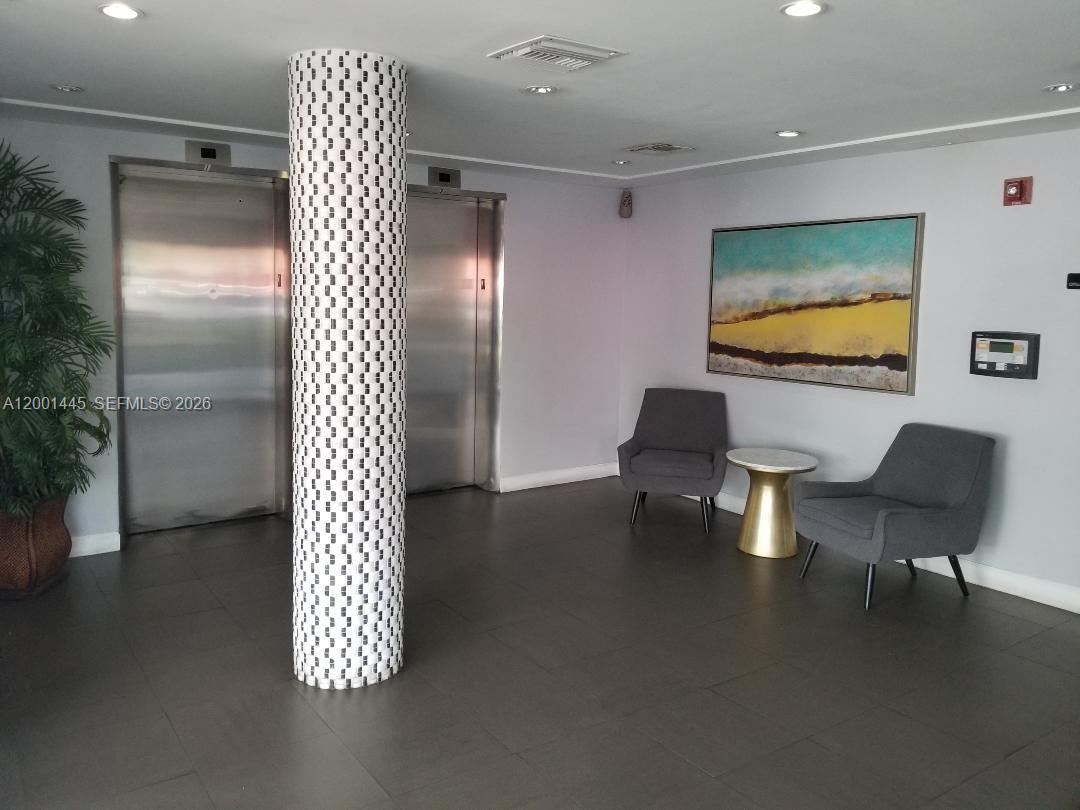 1300 Lincoln Road, Unit A301 Miami Beach, FL 33139 - Photo 5 of 23 a lobby with furniture and floor to ceiling window