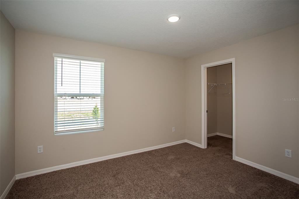 15232 Maude Lndg Loop Wimauma, FL 33598 - Photo 14 of 22 an empty room with windows