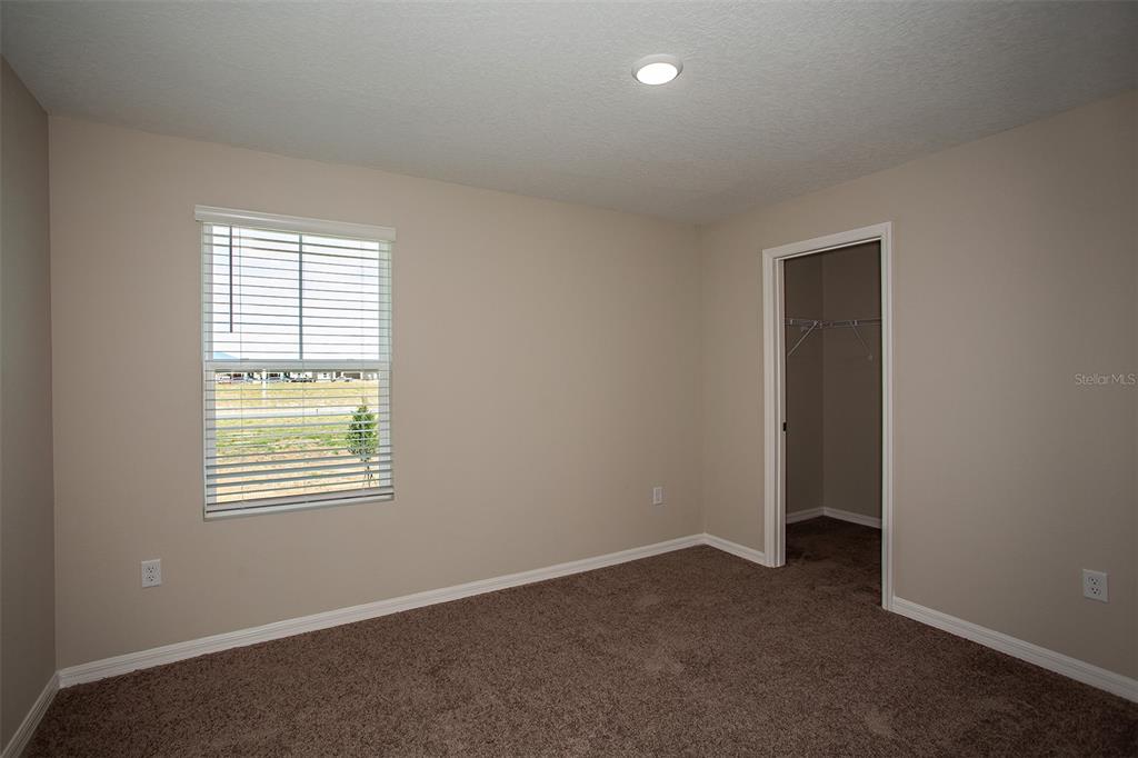 15232 Maude Lndg Loop Wimauma, FL 33598 - Photo 16 of 22 an empty room with windows