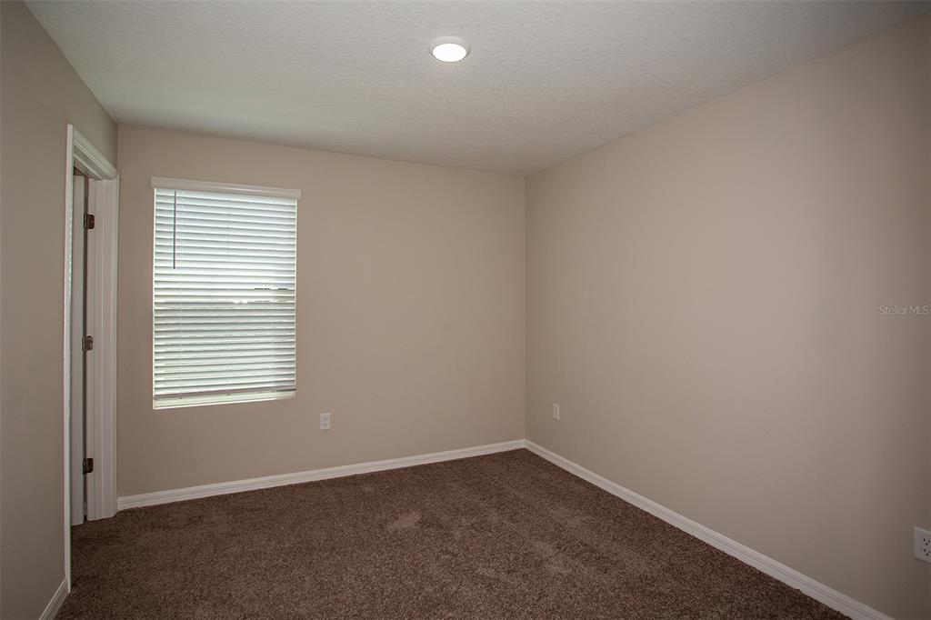 15232 Maude Lndg Loop Wimauma, FL 33598 - Photo 17 of 22 an empty room with a window