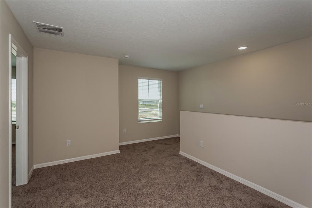 15232 Maude Lndg Loop Wimauma, FL 33598 - Photo 20 of 22 a view of an empty room with a window