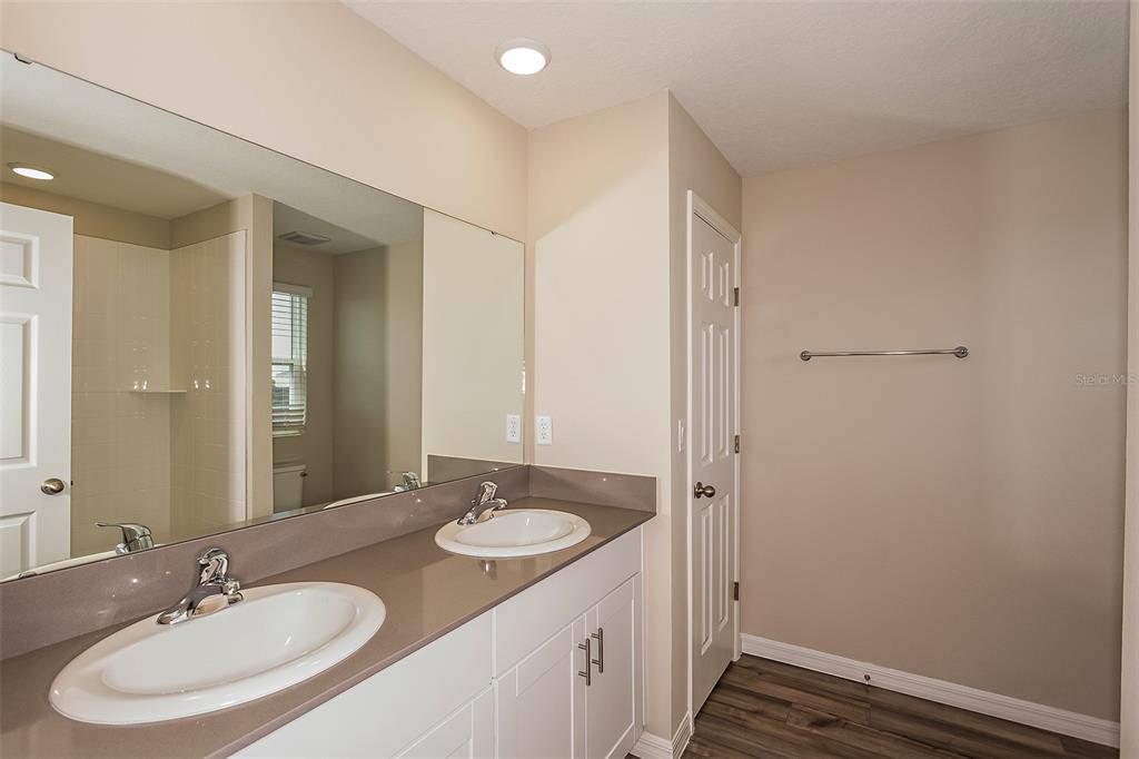 15232 Maude Lndg Loop Wimauma, FL 33598 - Photo 5 of 22 a bathroom with a sink double vanity and a mirror