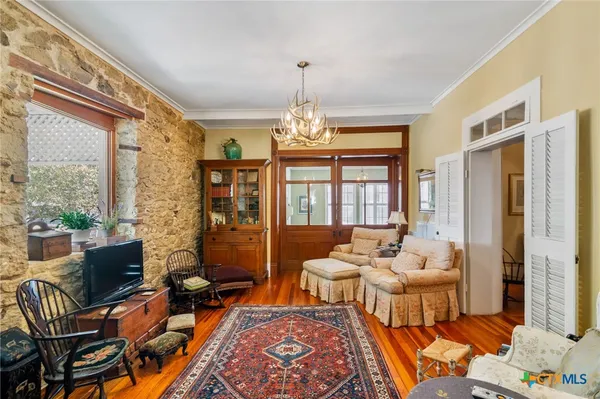 a living room filled with furniture and a chandelier