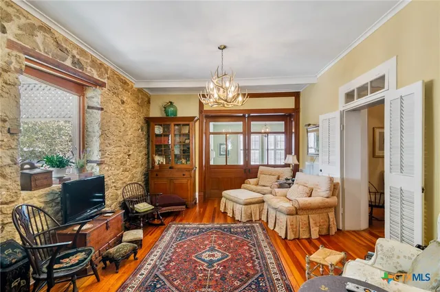 a living room filled with furniture and a chandelier