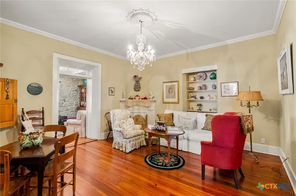 a living room with furniture and a chandelier