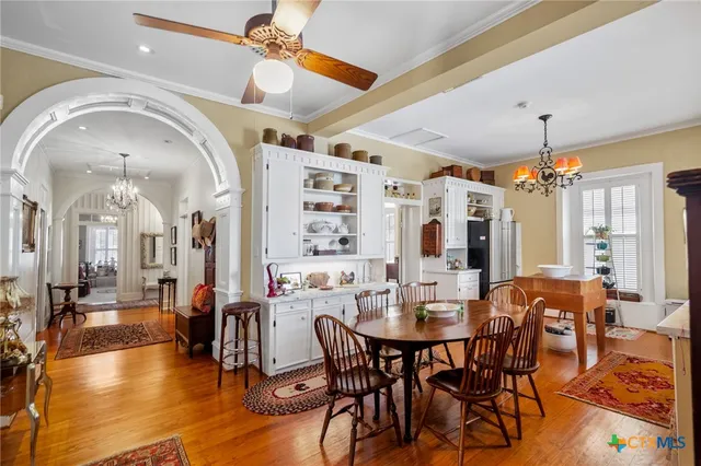 a view of a dining room with furniture and chandelier