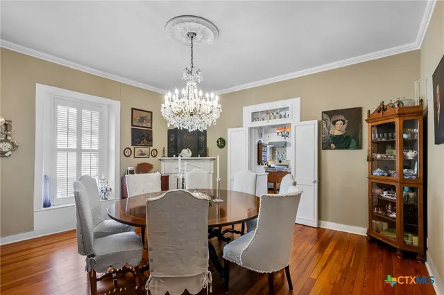 a view of a dining room with furniture wooden floor and chandelier